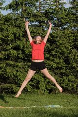 happy young woman is jumping
