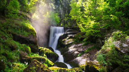 Black Forest - Triberg Waterfall with vapour and sunshine - obrazy, fototapety, plakaty