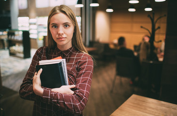 The student learns hard lessons or homework. Woman preparing for exams. Session at universities and institutes