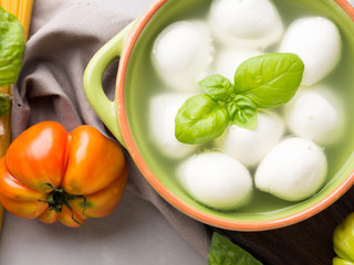 Italian food tomato mozzarella still life on gray rustic background. Traditional products