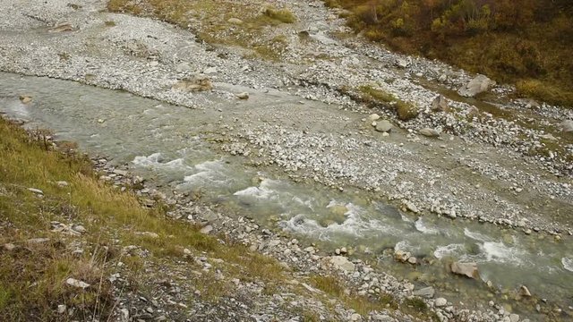 Amazing touristic place near river in mountain valley at the foot of Mt. Shkhara 5,193 m (17,040 ft). Upper Svaneti, Georgia, Europe. Caucasus mountains. HD video clip (High Definition).