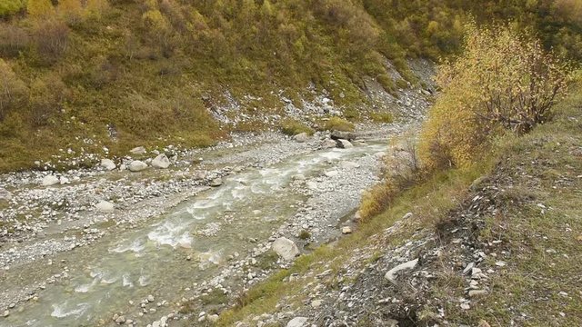 Amazing touristic place near river in mountain valley at the foot of Mt. Shkhara 5,193 m (17,040 ft). Upper Svaneti, Georgia, Europe. Caucasus mountains. HD video clip (High Definition).