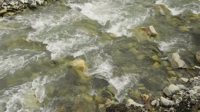 Amazing touristic place near river in mountain valley at the foot of Mt. Shkhara 5,193 m (17,040 ft). Upper Svaneti, Georgia, Europe. Caucasus mountains. HD video clip (High Definition).