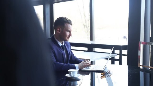 Businessman in the morning working on tablet computer in cafe with Cup of coffee