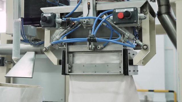 Bag filling machine. Device for filling bags in the factory, close-up