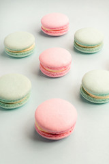 Fototapeta na wymiar Pink and mint colors macarons on blue background