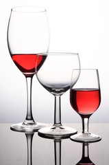 Three wineglasses with red wine isolated on white background