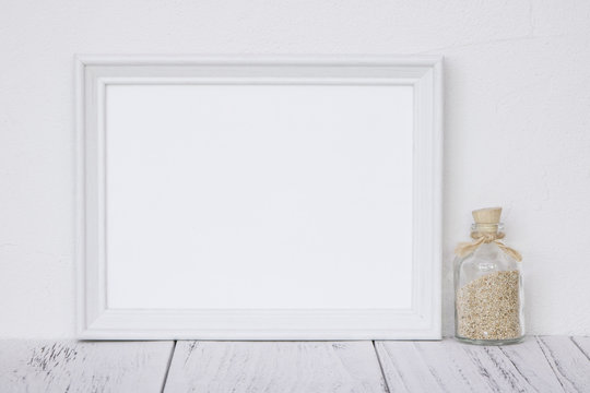 Stock photography white frame vintage painted wood table glass bottle and sand