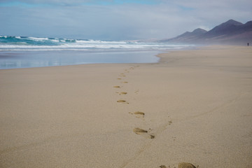 Footprints in sand on beautiful Cofete beach, Fuerteventura, Canary Islands, Spain
