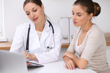 Doctor and  patient  sitting at the desk. The physician or therapist makes a diagnosis. Health care, medicine and patient service concept