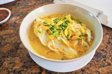 A Bowl of Num Banh Chok, or Traditional Cambodian Rice Noodles Topped with Herbs