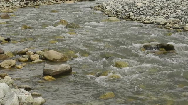 Amazing touristic place near river in mountain valley at the foot of Mt. Shkhara 5,193 m (17,040 ft). Upper Svaneti, Georgia, Europe. Caucasus mountains. HD video clip (High Definition).