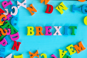 brexit or british exit - word composed of small colored letters on blue background