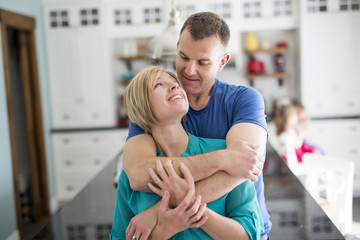 Fototapeta premium Happy couple in kitchen having fun together