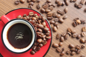 espresso and coffee beans on wooden background