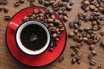 espresso and coffee beans on wooden background