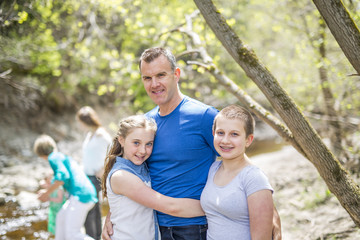 Fototapeta premium Happy young father with daughters outdoors
