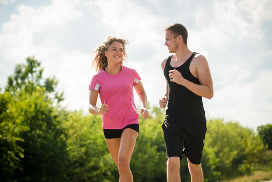 Young couple running together. Fitness concept.