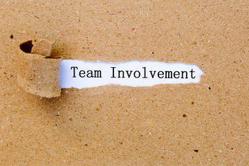 Team Involvement - printed text underneath torn brown paper
