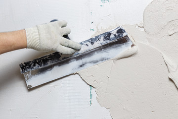 Plasterer working with plastering trowel
