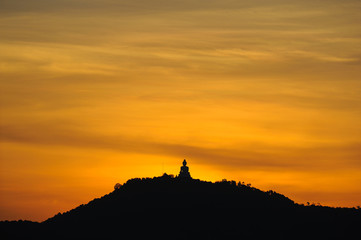 Silhouette of Big Buddha on top of mountain