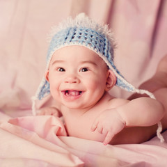 Beautiful expressive adorable big-eared baby laughing and smiling
