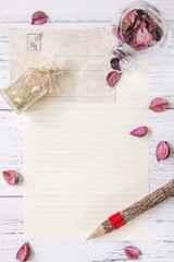 Flat lay stock photography purple flower petals letter envelope paper glass bottle wood pencil sea sand