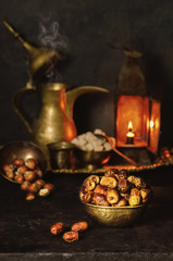 Ramadan Background with delicious premium  dates places with traditional old lamp,arabian coffee  pot,sugar and nuts..Ramadan food 