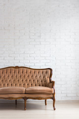 retro sofa over white brick wall