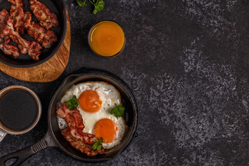 Breakfast with bacon , fried egg, coffee and orange juice.