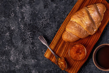 Fresh croissant on dark background.