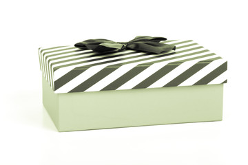 Pink gift box with a lid in a white and blue stripes and a blue satin bow. Toned