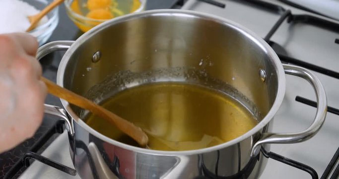 Cooking caramel. Chef preparing caramel in the pan. Boil sugar. The technical process of preparation of caramel. Shot 4K footage at 10 bit.