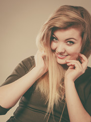 Obraz premium Attractive blonde woman wearing tight green khaki top