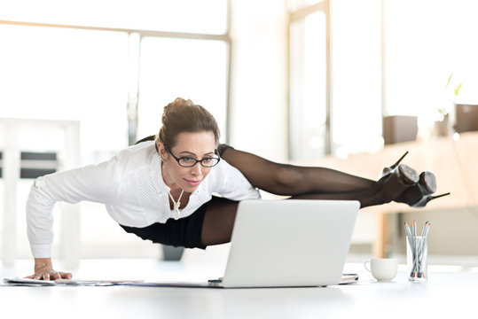 Happy woman doing exercises during working day