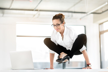 Outgoing woman having awkwarded pose in office