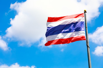 Image of waving Thai flag of Thailand with blue sky background