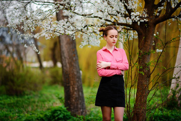 Sensuality. Happy beautiful young woman relaxing in blossom park