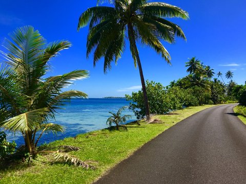Street along the coast and lagoon of Tahaa, Tahiti, French Polynesia