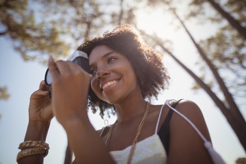 Low angle view of woman photographing