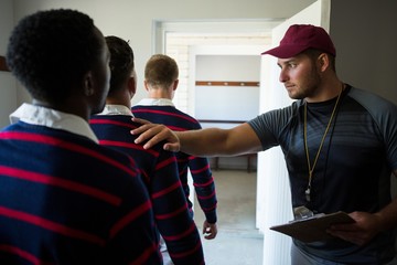 Coach motivating rugby team