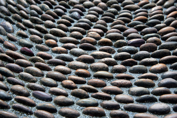 Pebbles stone pattern on the floor for foot massage.