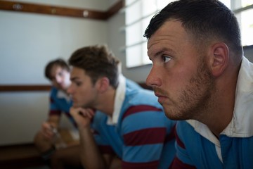 Close up of thoughtful rugby players looking away 