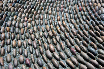 Pebbles stone pattern on the floor for foot massage.
