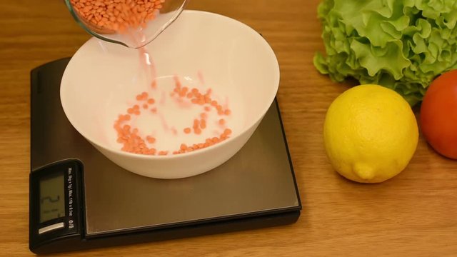 Lentil seeds are weighed on the scales