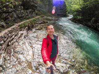 man in canyon making selfie