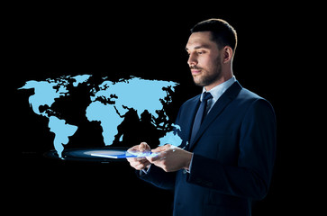 businessman with tablet pc and world map