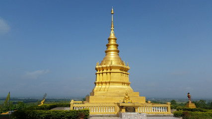 Fototapeta premium Golden Pagoda is a beautiful with blue sky background.