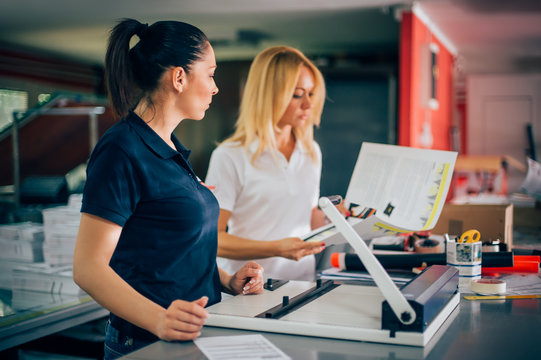 Two Young Woman Working In Printing Factory