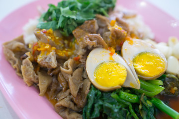 Stewed pork leg on rice with boiled egg.
